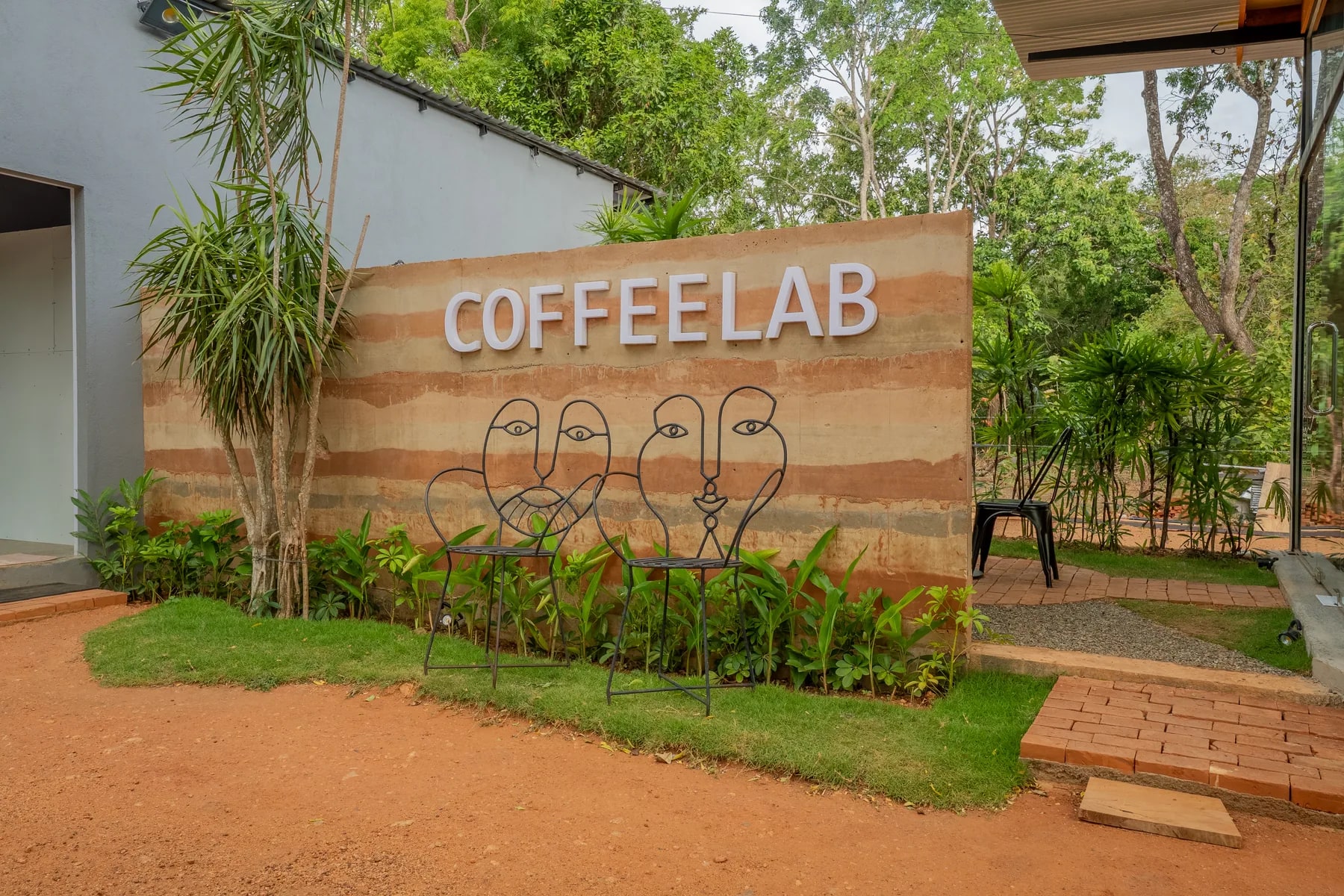 The CoffeeLab exterior and signature wall in Sigiriya