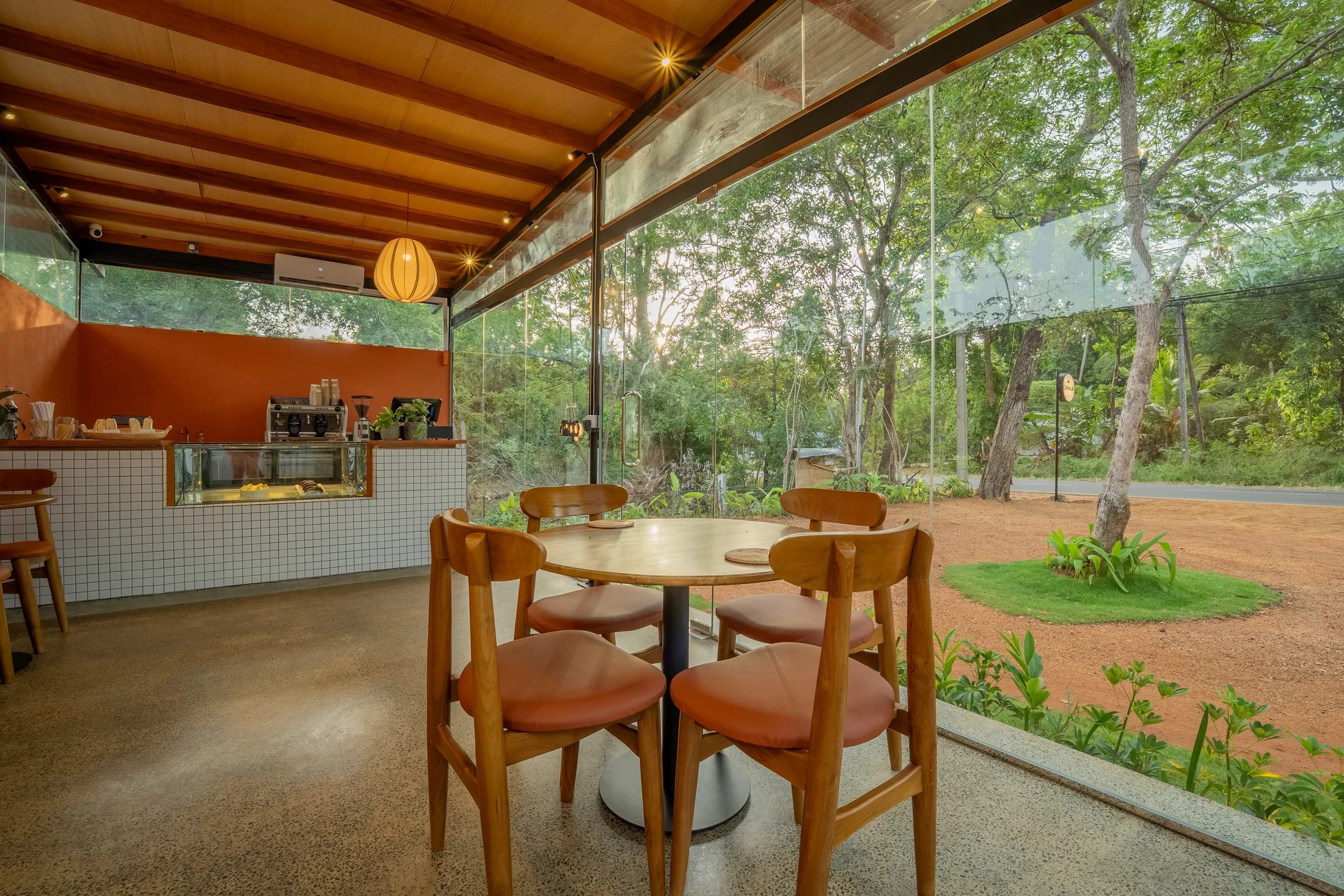 The bright glass-walled interior of CoffeeLab Sigiriya