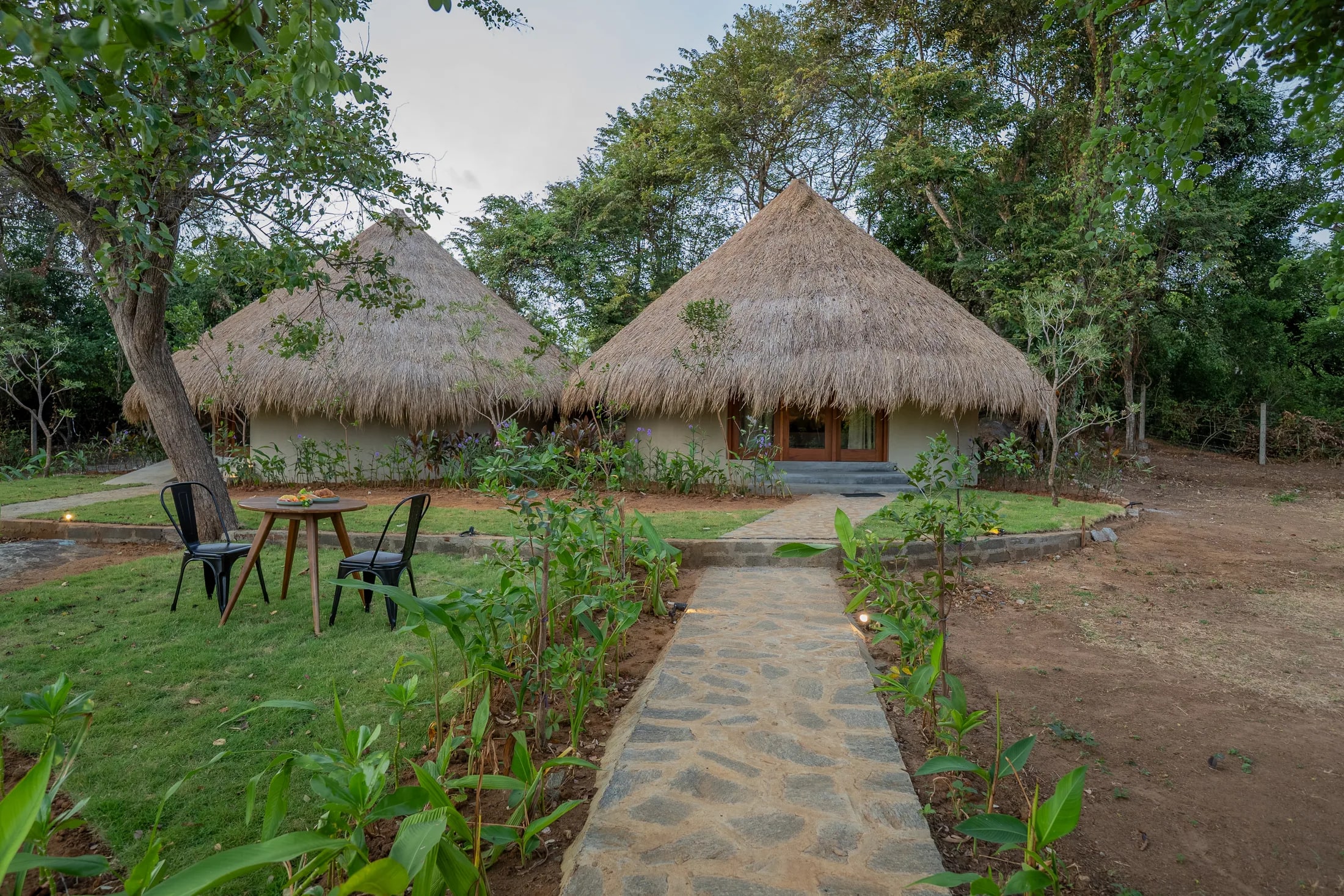 Thatched garden cottages at Tranquil Trails Sigiriya